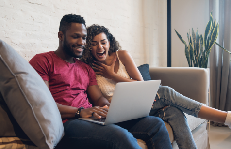 young-couple-spending-time-together-while-using-laptop-home-new-normal-lifestyle-concept