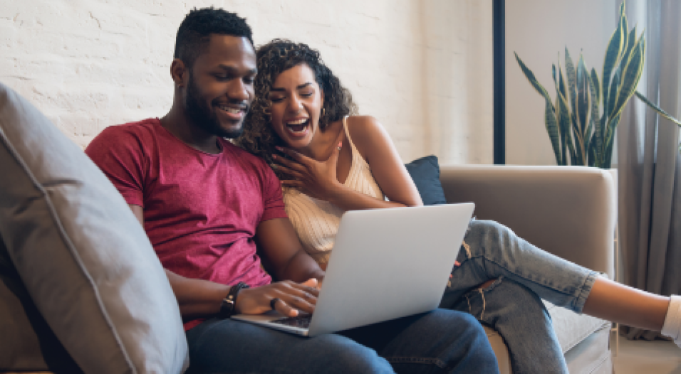 young-couple-spending-time-together-while-using-laptop-home-new-normal-lifestyle-concept